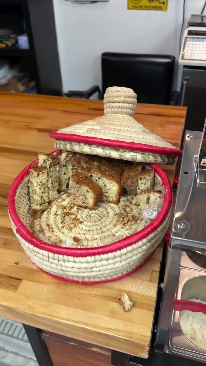 Fresh injera in a woven mesob basket on the counter